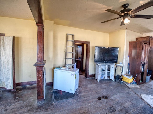 unfurnished living room with ornate columns and ceiling fan