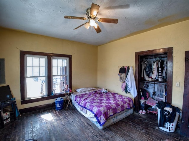 bedroom with a textured ceiling, ceiling fan, and hardwood / wood-style flooring