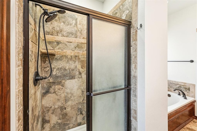 full bath featuring a garden tub and a shower stall