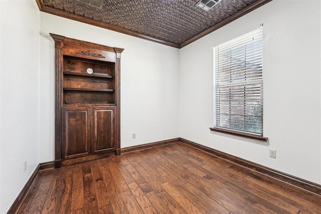 spare room with baseboards, an ornate ceiling, dark wood-type flooring, and crown molding