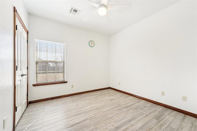 empty room with light wood finished floors, visible vents, baseboards, and ceiling fan