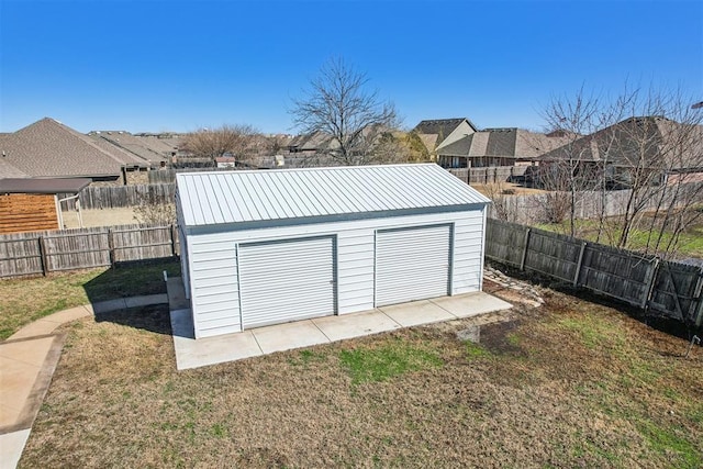 detached garage featuring fence