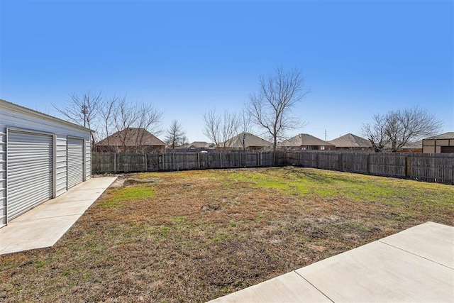 view of yard with an outbuilding and a fenced backyard