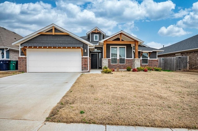 craftsman inspired home with brick siding, a front lawn, fence, concrete driveway, and a garage