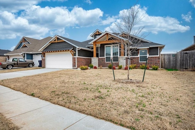 craftsman-style house with a front yard, fence, an attached garage, concrete driveway, and brick siding