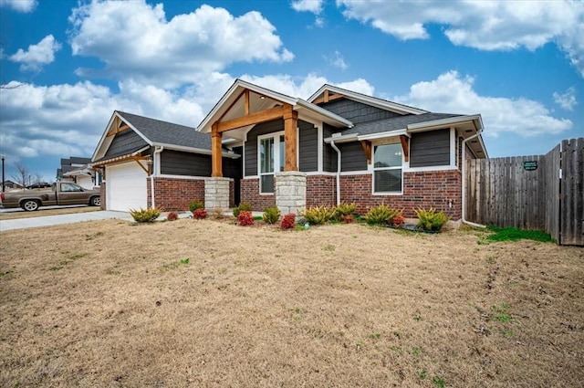 craftsman-style house with brick siding, concrete driveway, an attached garage, and fence