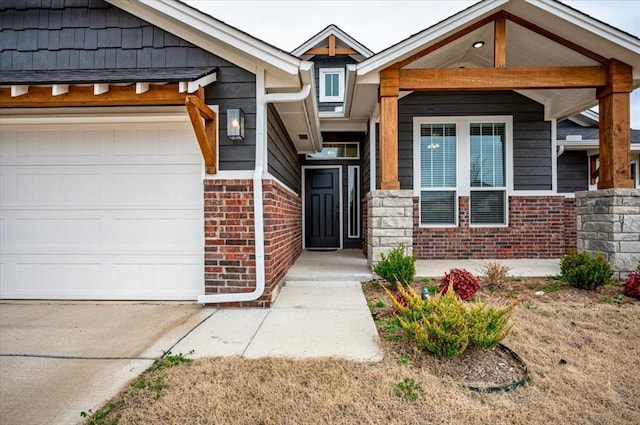 property entrance featuring a garage and brick siding