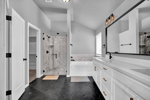 full bath featuring a sink, a marble finish shower, tile patterned flooring, lofted ceiling, and a bath