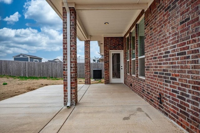 view of patio featuring fence and central AC