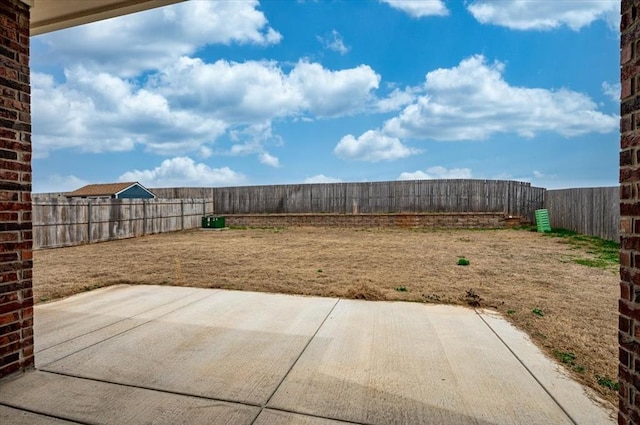 view of yard with a fenced backyard and a patio area