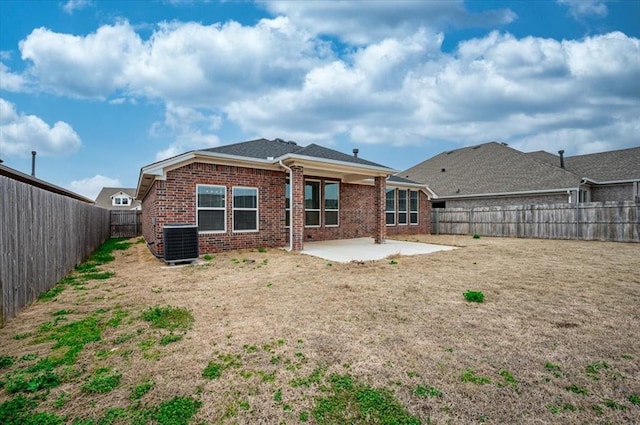 back of house with brick siding, central air condition unit, a patio area, and a fenced backyard