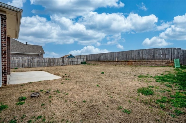 view of yard with a fenced backyard and a patio