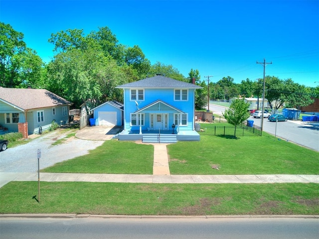 view of front facade featuring an outbuilding, fence, driveway, a front lawn, and a detached garage