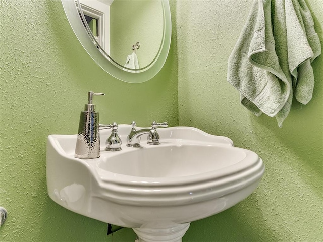 bathroom with a sink and a textured wall