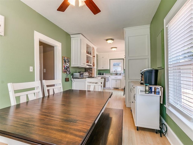 dining room with light wood-style floors and ceiling fan