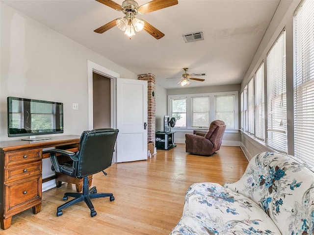 office space with visible vents, baseboards, light wood-style flooring, and a ceiling fan