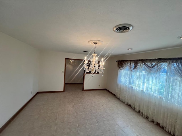 unfurnished dining area with an inviting chandelier, baseboards, and visible vents