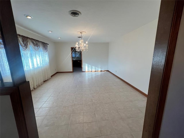 unfurnished room featuring a chandelier, visible vents, baseboards, and light tile patterned floors