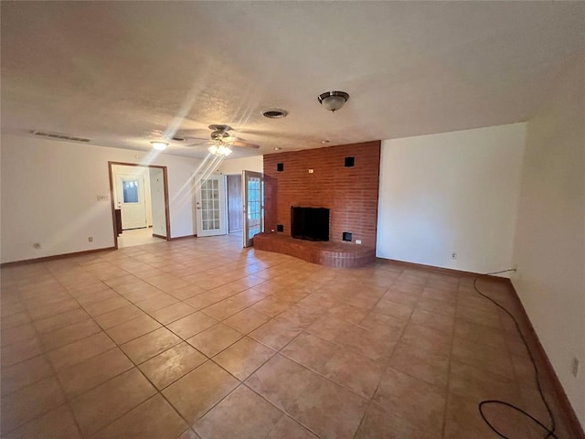 unfurnished living room featuring light tile patterned flooring, a fireplace, baseboards, and ceiling fan