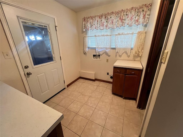 interior space featuring baseboards and light tile patterned flooring