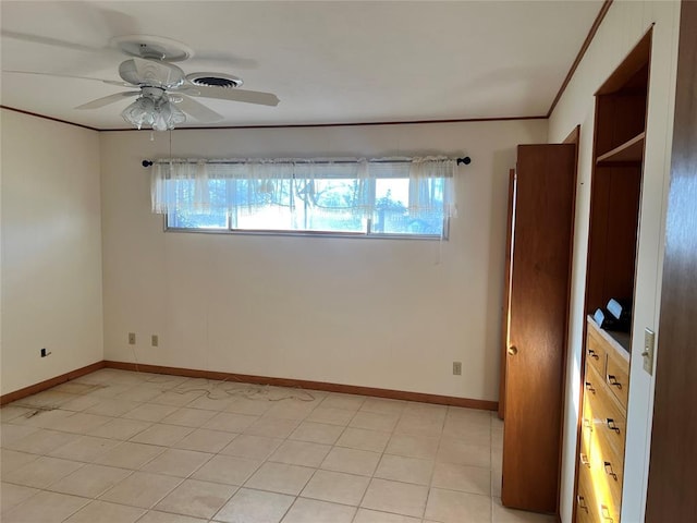 unfurnished room featuring plenty of natural light, baseboards, ceiling fan, and ornamental molding