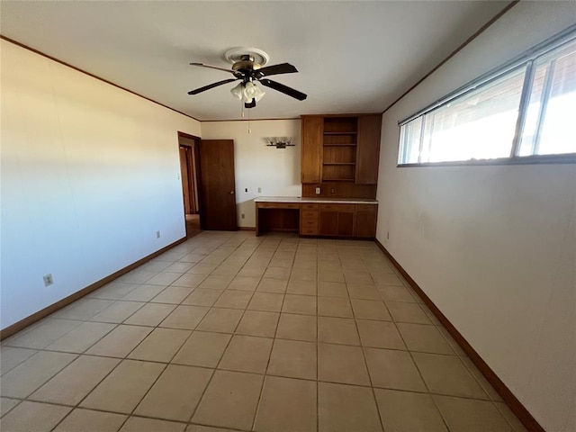 kitchen featuring open shelves, light tile patterned floors, baseboards, ceiling fan, and built in study area