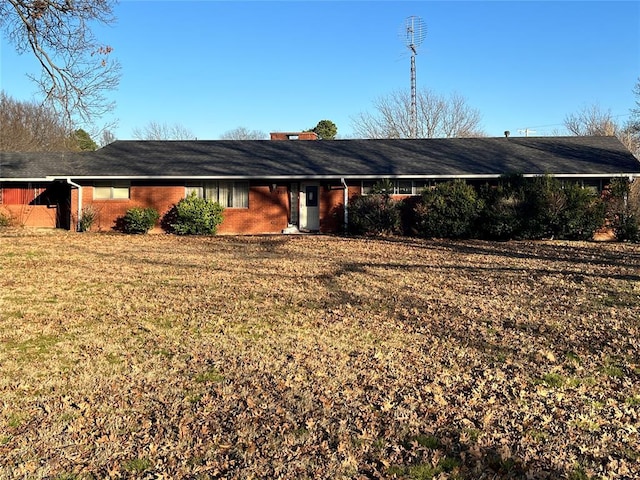 exterior space featuring a yard and brick siding