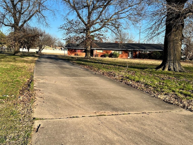 exterior space featuring a yard and driveway