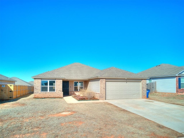 ranch-style house with fence, driveway, an attached garage, a shingled roof, and brick siding