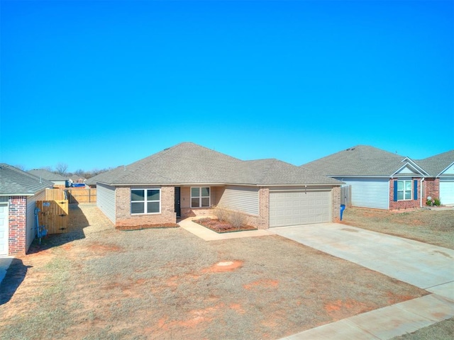 ranch-style home featuring fence, driveway, a shingled roof, a garage, and brick siding