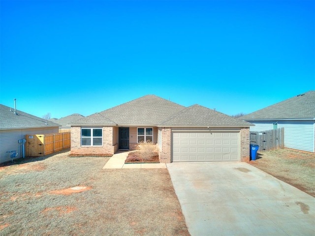 ranch-style house featuring an attached garage, fence, driveway, and roof with shingles