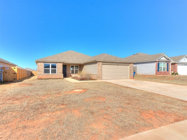 ranch-style house with driveway, fence, roof with shingles, an attached garage, and brick siding