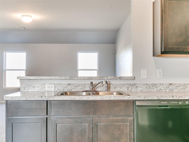 kitchen with visible vents, light countertops, black dishwasher, and a sink