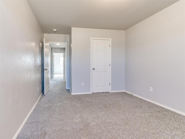 unfurnished bedroom with baseboards and carpet