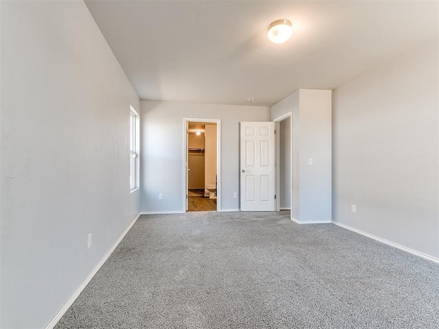 unfurnished bedroom with carpet and baseboards