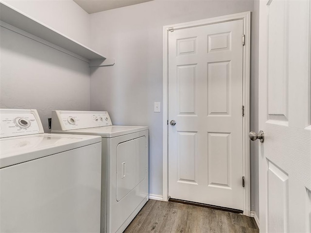 laundry room with laundry area, light wood-style floors, and washing machine and clothes dryer