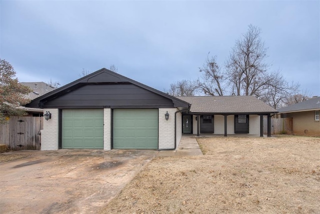 ranch-style house featuring a garage, brick siding, concrete driveway, and fence