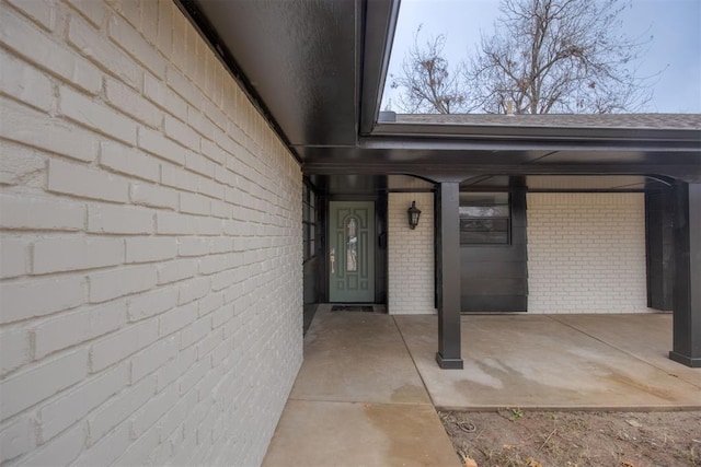 property entrance featuring brick siding