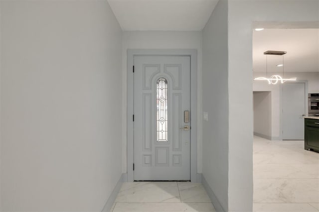 foyer with baseboards and marble finish floor