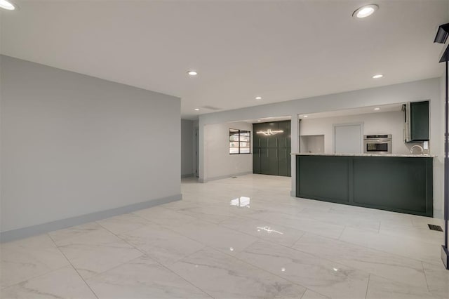 unfurnished room featuring recessed lighting, baseboards, and marble finish floor