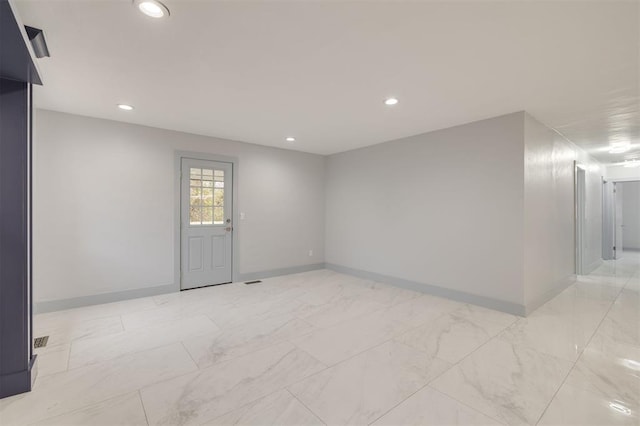 unfurnished room featuring recessed lighting, baseboards, and marble finish floor