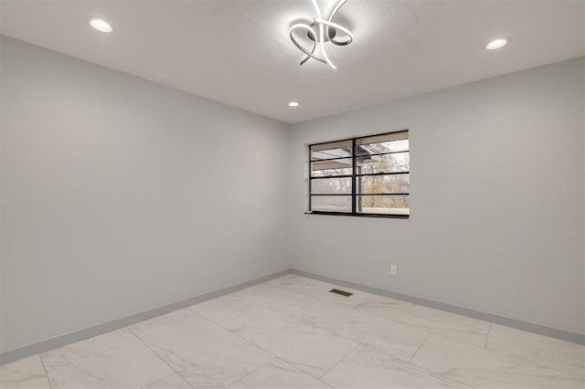 empty room with recessed lighting, visible vents, marble finish floor, and baseboards