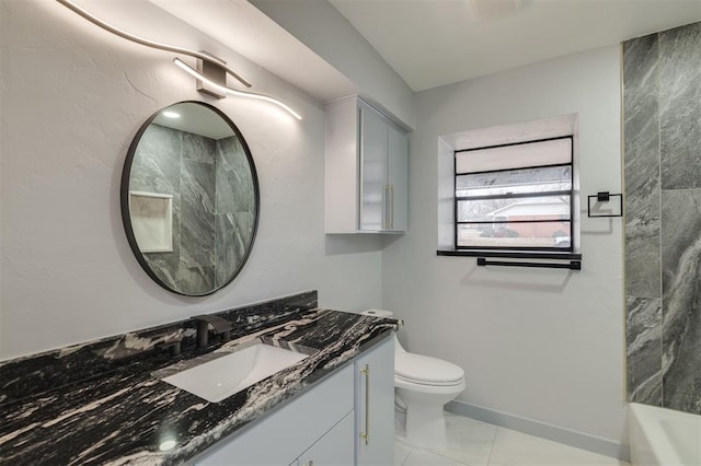 bathroom with vanity, toilet, and baseboards