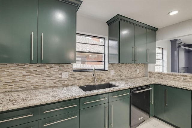 2418 NW 43rd Cir, Oklahoma City, OK 73112 - kitchen featuring light stone countertops, green cabinetry, decorative backsplash, and a sink