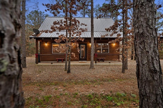 view of front of house featuring covered porch and metal roof