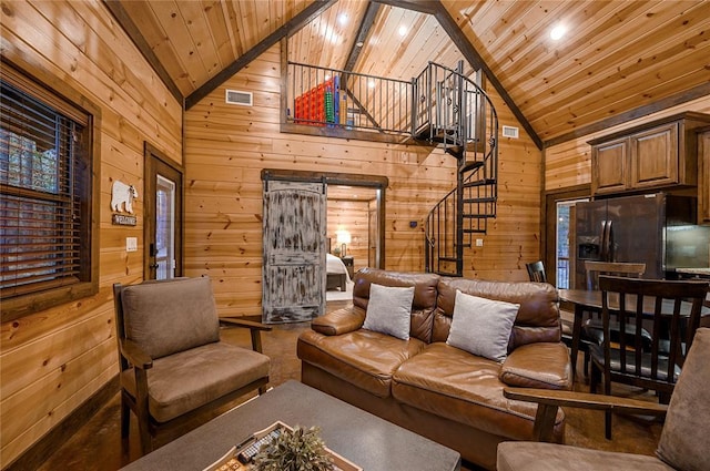 living area with stairs, wooden ceiling, visible vents, and wood walls