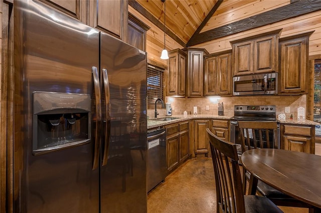 kitchen featuring a sink, appliances with stainless steel finishes, decorative backsplash, lofted ceiling, and light stone countertops