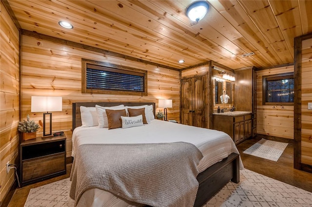 bedroom with wooden ceiling, wood walls, and a sink