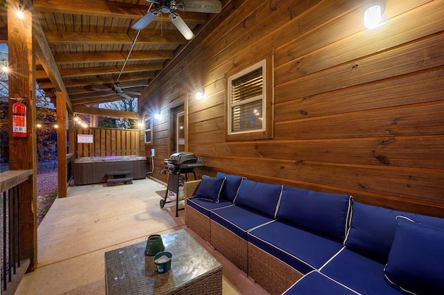 interior space with lofted ceiling with beams, wood ceiling, wood walls, and ceiling fan