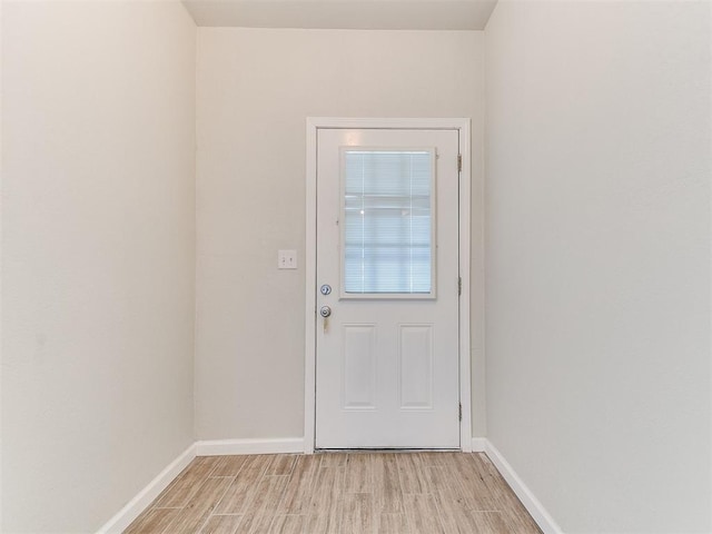 entryway featuring baseboards and light wood-type flooring